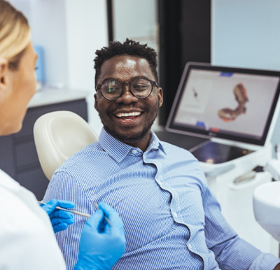 a man talking to a dentist