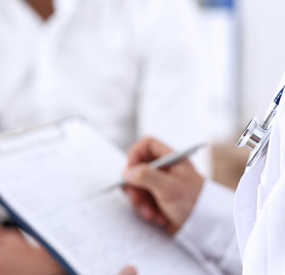 Doctor making notes about patient’s sleep apnea symptoms