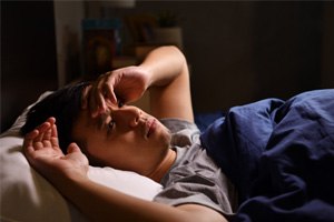 man lying awake with sleep apnea