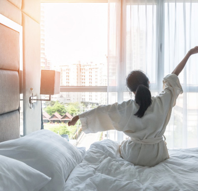 a woman waking up and stretching in the morning