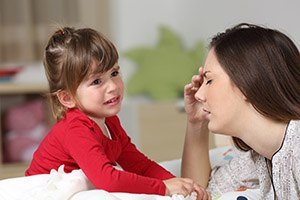 Exhausted mom with crying child