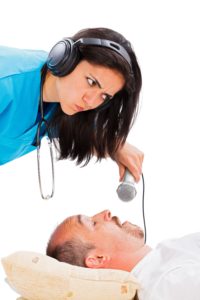 doctor listening to snoring man