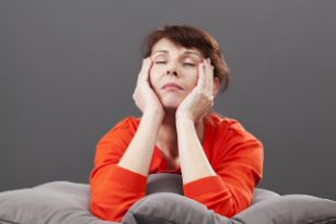 A woman rubbing her temples