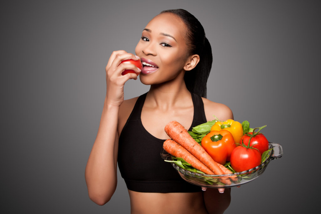 woman smiling eating healthy foods