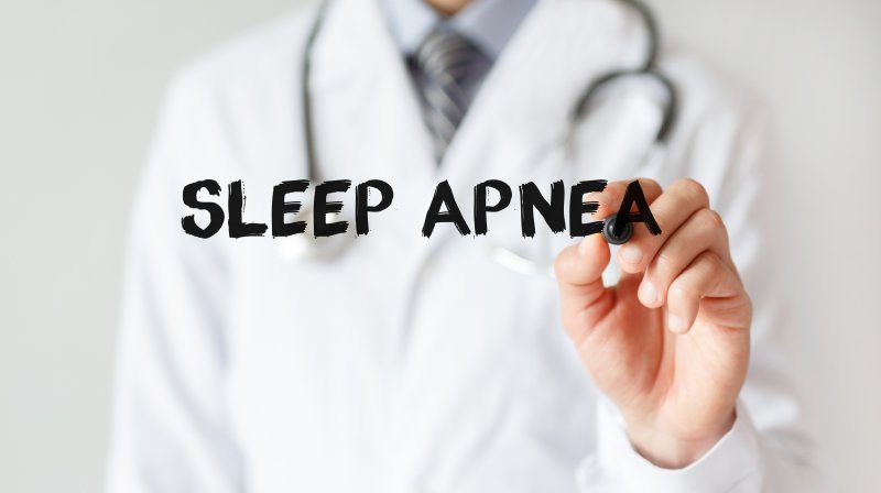 a doctor writing the words “sleep apnea”