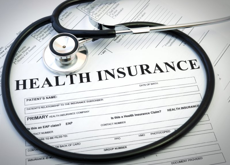 Stethoscope around a medical insurance form