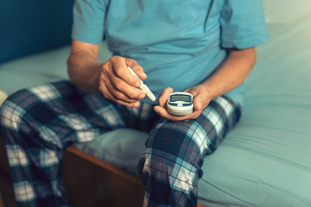 Man checking his blood sugar level in the morning.