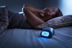 Person struggling to sleep because of sleep apnea