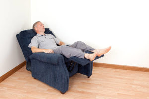 Man sleeping in a blue recliner