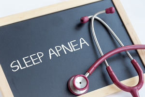 Stethoscope and chalkboard with the words “sleep apnea”