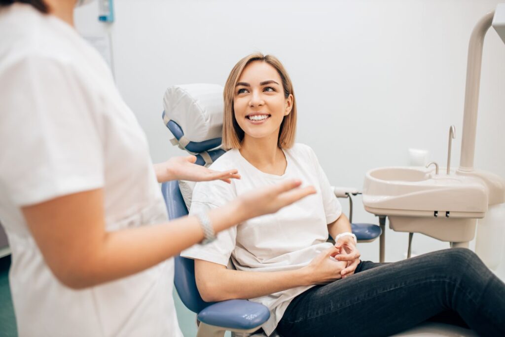 A woman discussing sleep apnea with her dentist