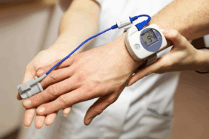 Sleep dentist checking a patient’s sleep apnea monitor 